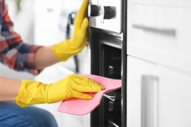 cleaning an oven by house cleaning services in Mount Prospect